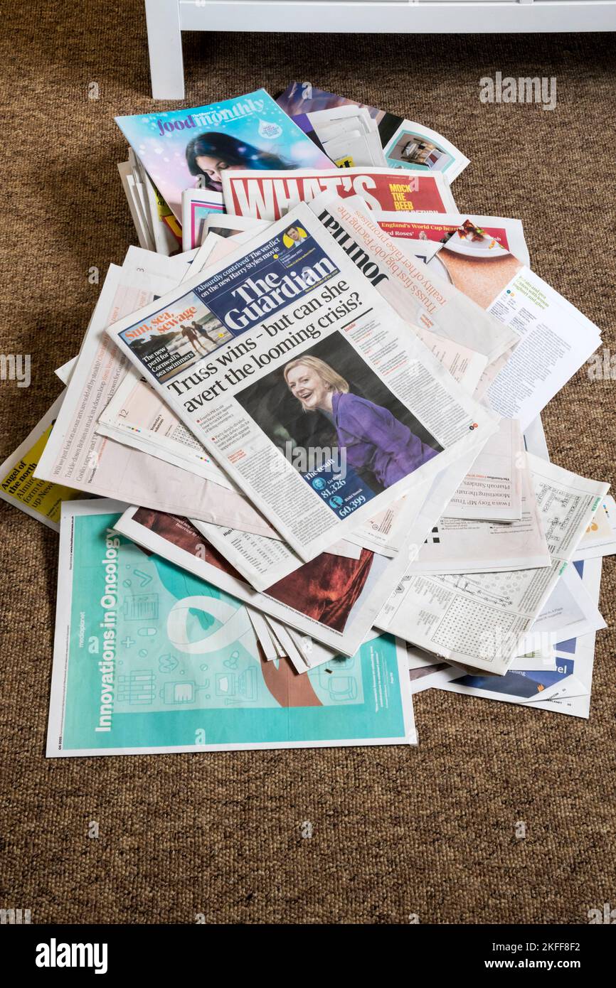 A copy of The Guardian with the headline Truss wins - but can she avert the looming crisis on top of a pile of old newspapers. Stock Photo
