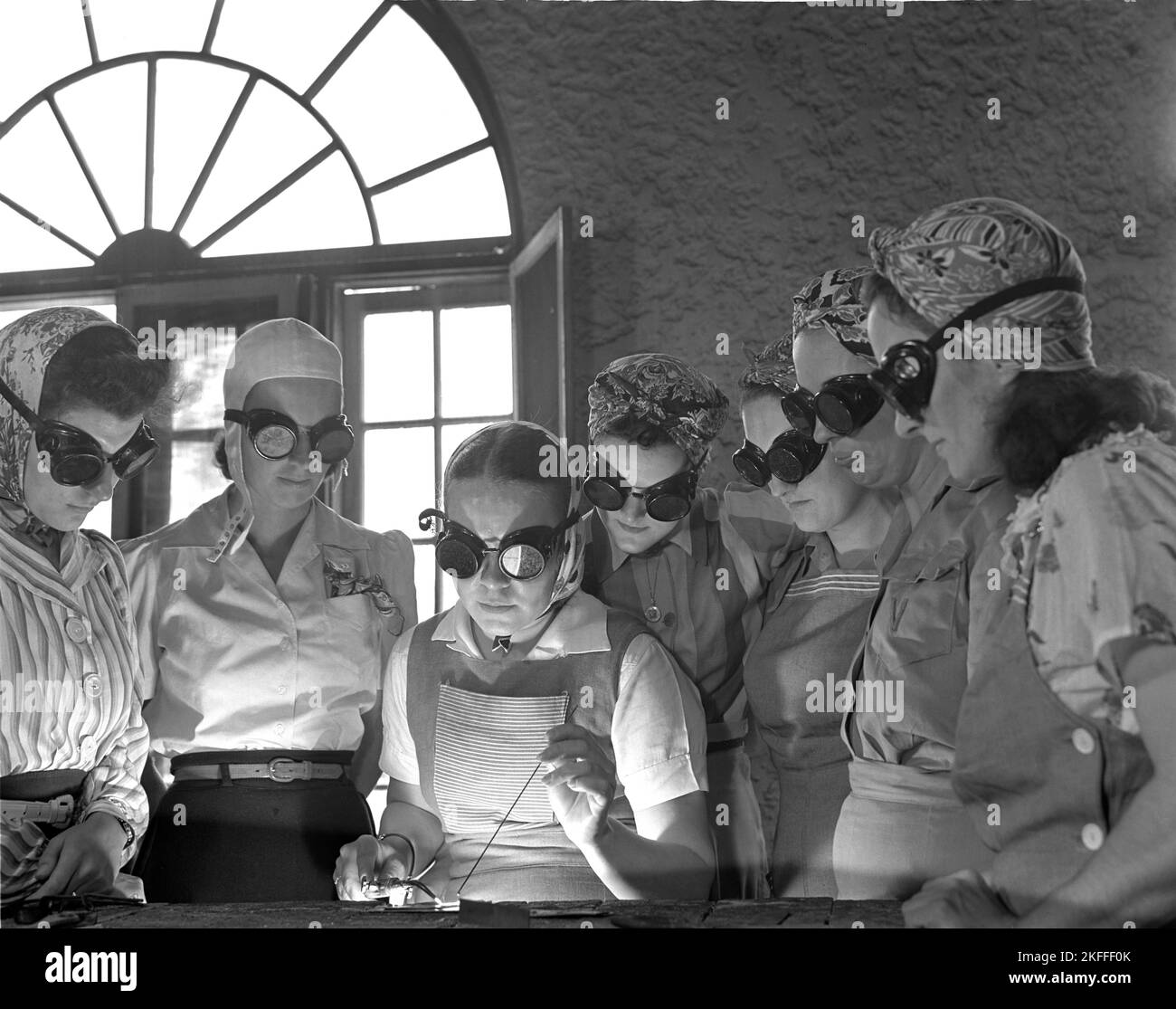 Unidentified American women circa April 1942 being shown welding techniques for aircraft construction to help the war effort during world war two Stock Photo