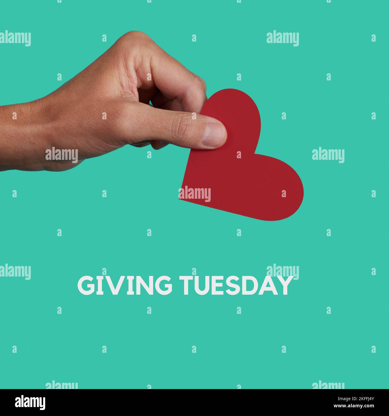 the text giving tuesday and a man giving a red heart on a greenish blue background, in a square format Stock Photo