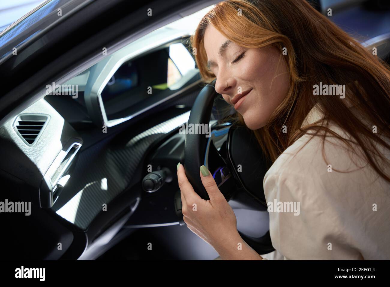 Happy female driver napping in her motorcar Stock Photo