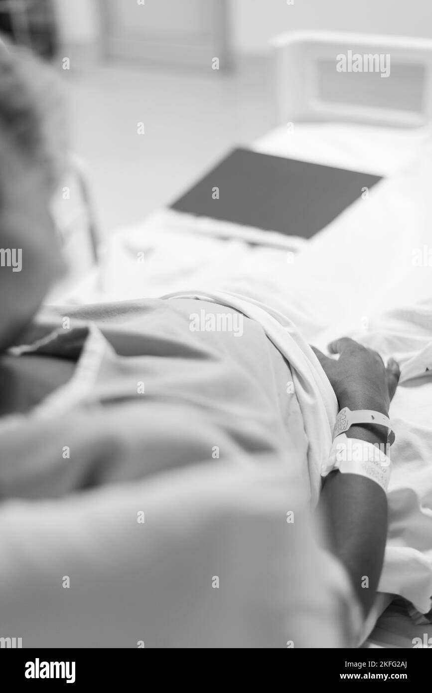 A pregnant woman in labor, lying in a hospital bed waiting for her baby to be born. Stock Photo