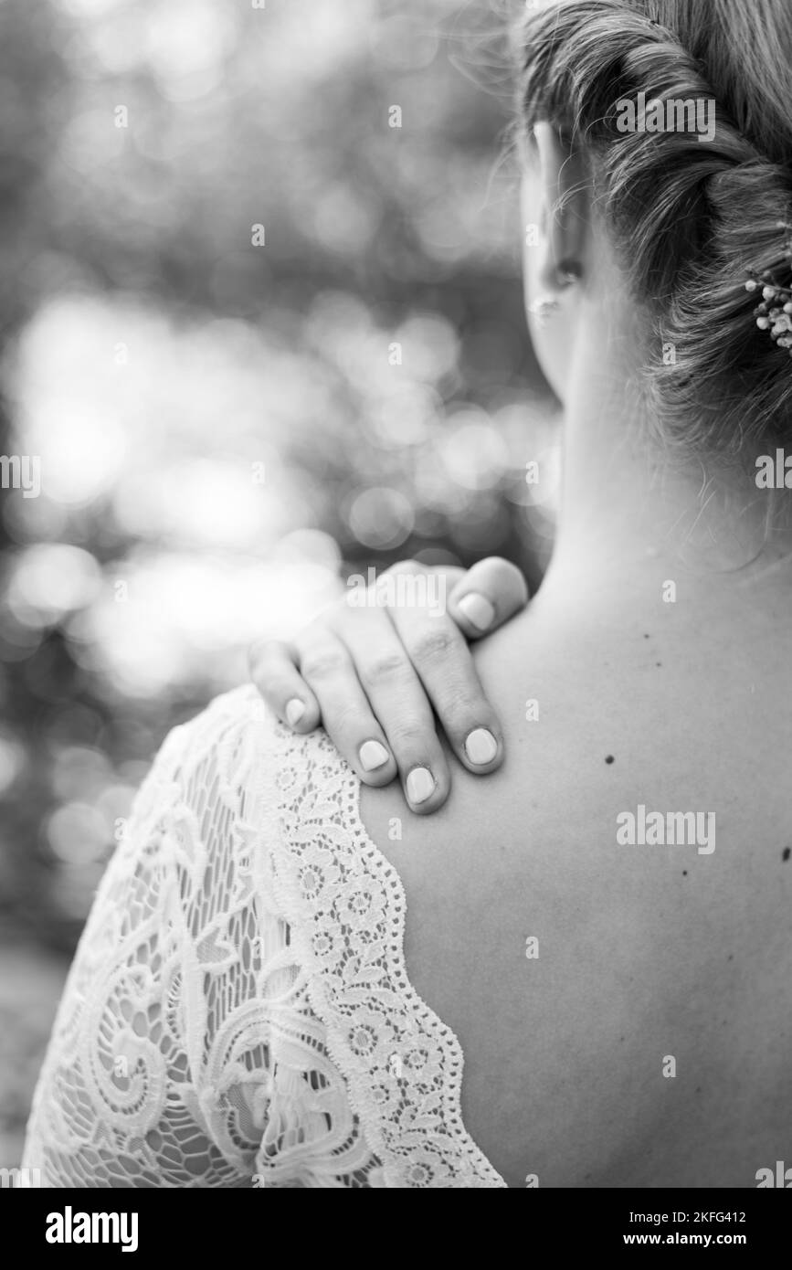 The. back of a bride  with her lace wedding dress and flowers in her hair on her minimalistic wedding day Stock Photo