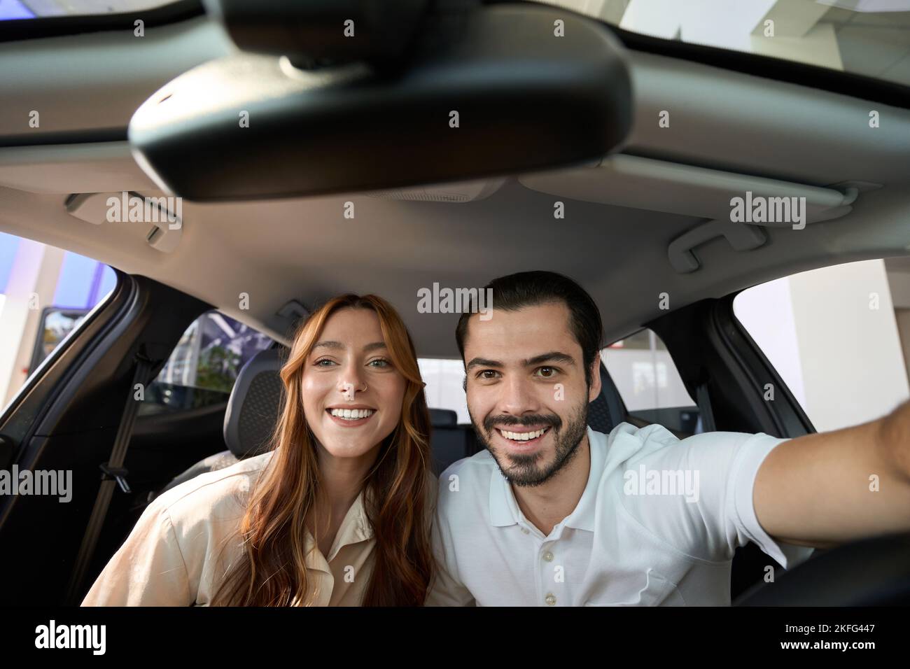 Happy couple taking selfies in new vehicle Stock Photo