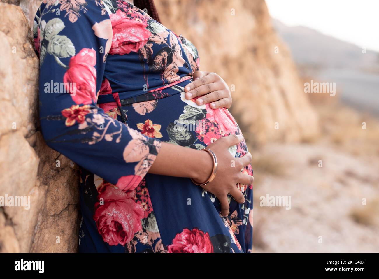 An expectant mom holding her pregnant abdomen Stock Photo