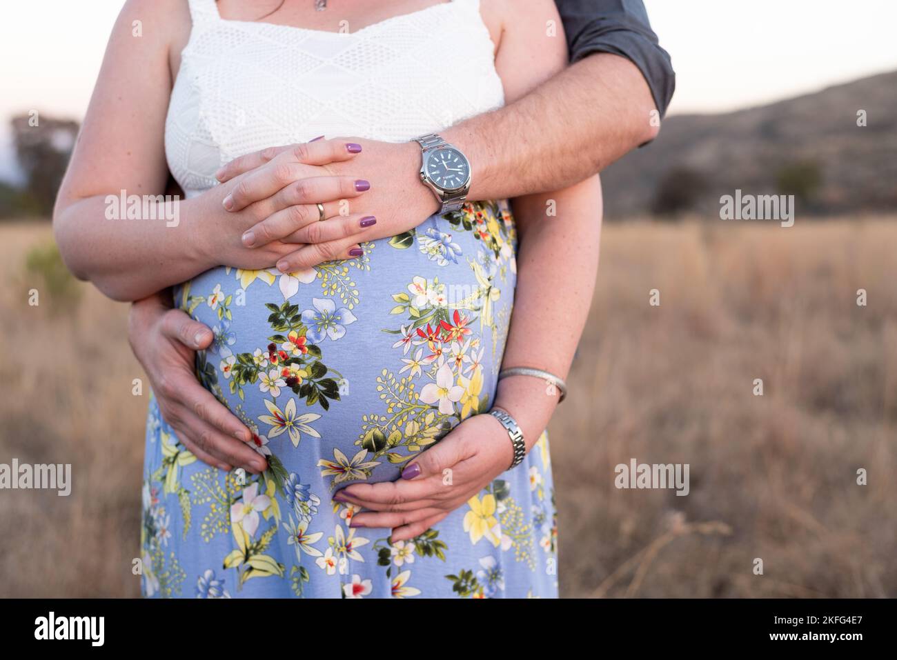 A close up of a couple holding the woman's pregnant tummy Stock Photo