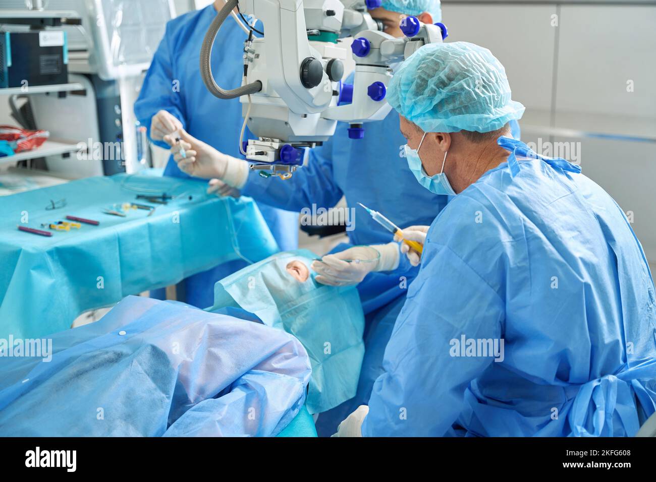Two doctors doing laser vision correction in hospital Stock Photo