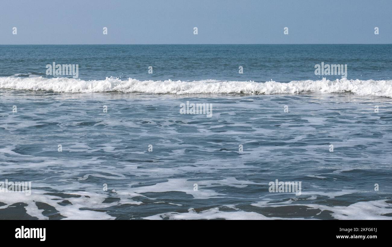 Sea shore with gentle waves and patterns of sea surf and tidal flow at Penbryn beach Cardigan Bay in south west Wales UK Stock Photo