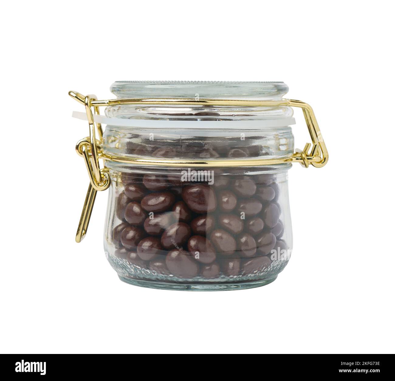 Closed glass jar with dragee chocolate-covered raisins, isolated on white background Stock Photo