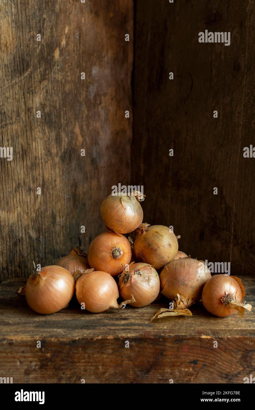 Vertical shot of white onions with an old wooden background Stock Photo