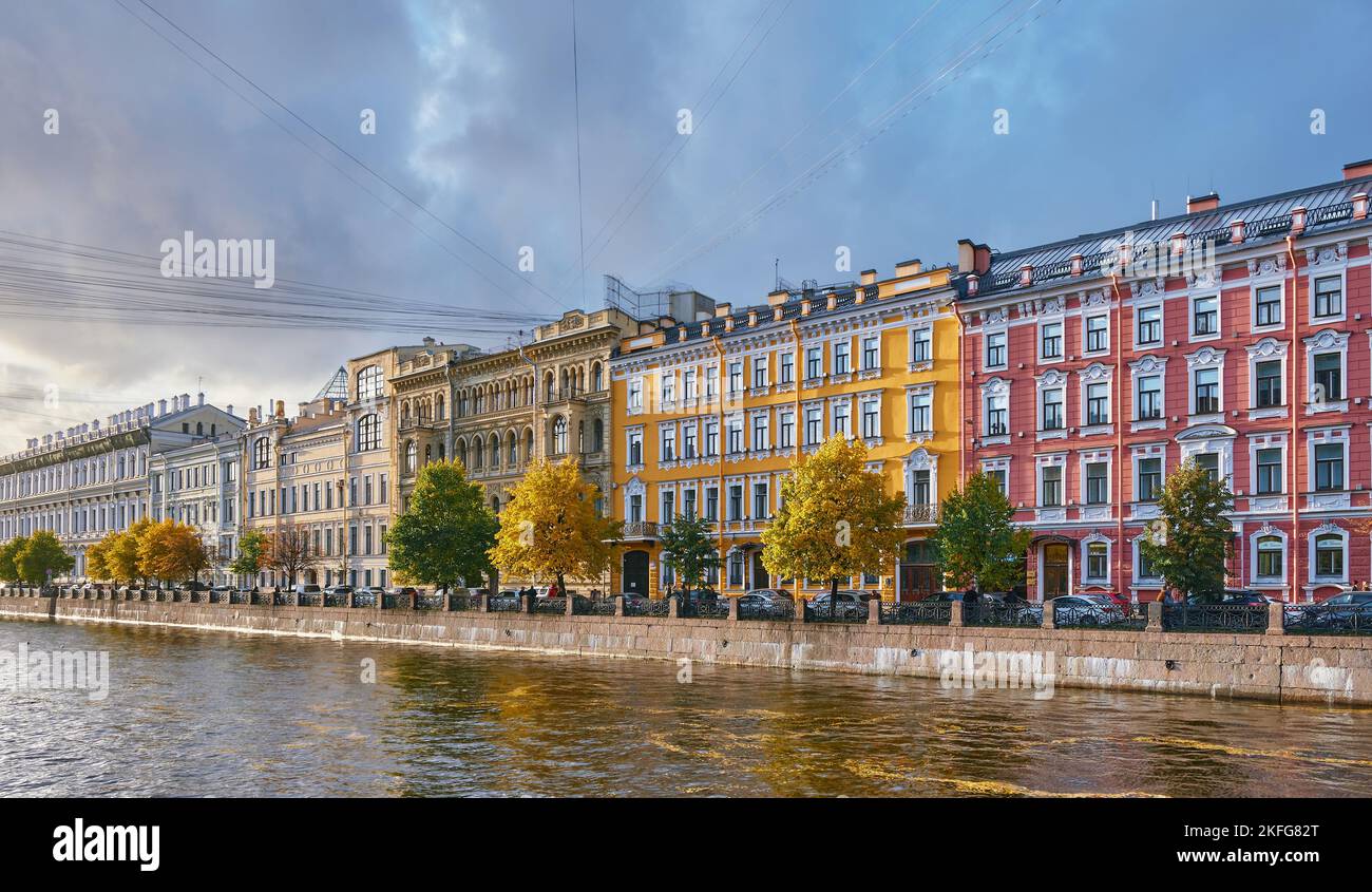 View of beautiful colorful old houses at sunset, built in the 19th and 20th centuries, Fontanka River embankment, cityscape: St. Petersburg, Russia - Stock Photo