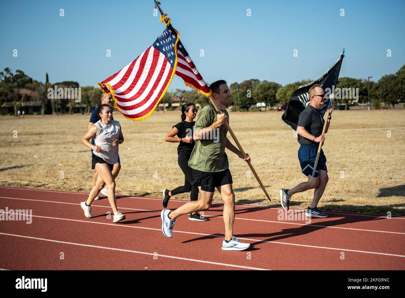 U.S. Airmen honor the legacy of Prisoners of War and Missing in Action service members from various conflicts during the annual 24-hour POW/MIA Remembrance Run at Travis Air Force Base, California, Sept. 15, 2022. Service members, civilians and family members kept the American flag and POW/MIA flag in constant motion for a 24-hour period. According to the Defense POW/MIA Accounting Agency, more than 82,000 Americans remain missing from World War II, the Korean War, the Vietnam War, the Cold War, the Gulf Wars and other conflicts. The names of unaccounted service members were recited during the Stock Photo