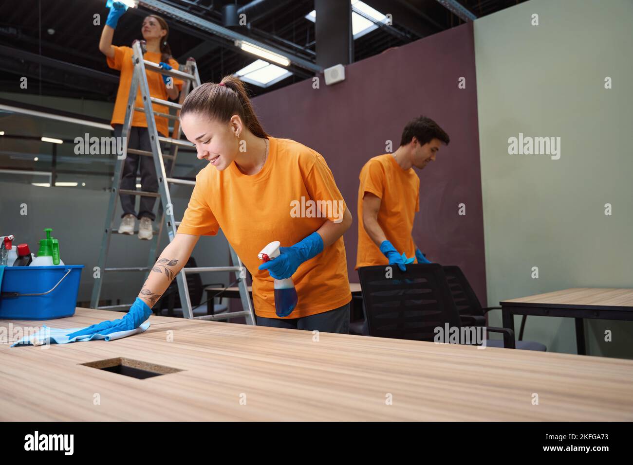 Professional cleaners working hard to make the room look nice Stock