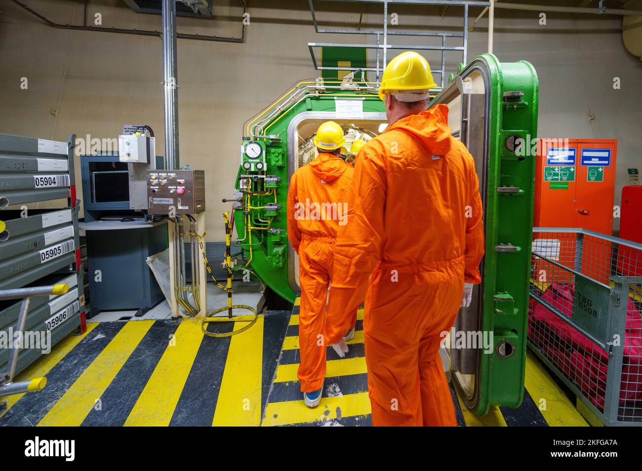Biblis, Germany. 18th Nov, 2022. People walk through an airlock in a power plant unit. The Biblis nuclear power plant has been undergoing decommissioning since it was shut down. This process is expected to last until beyond 2030. Credit: Andreas Arnold/dpa/Alamy Live News Stock Photo