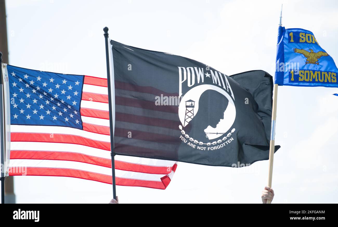 Air Commandos carry an American flag, a POW/MIA flag and a 1st Special Operations Squadron guidon during a 24-hour vigil run at Hurlburt Field, Florida, Sept. 15, 2022. The run serves to honor and remember POW/MIA American service members from World War II, the Korean War, the Vietnam War, the Cold War, the Gulf Wars and other recent conflicts. Stock Photo