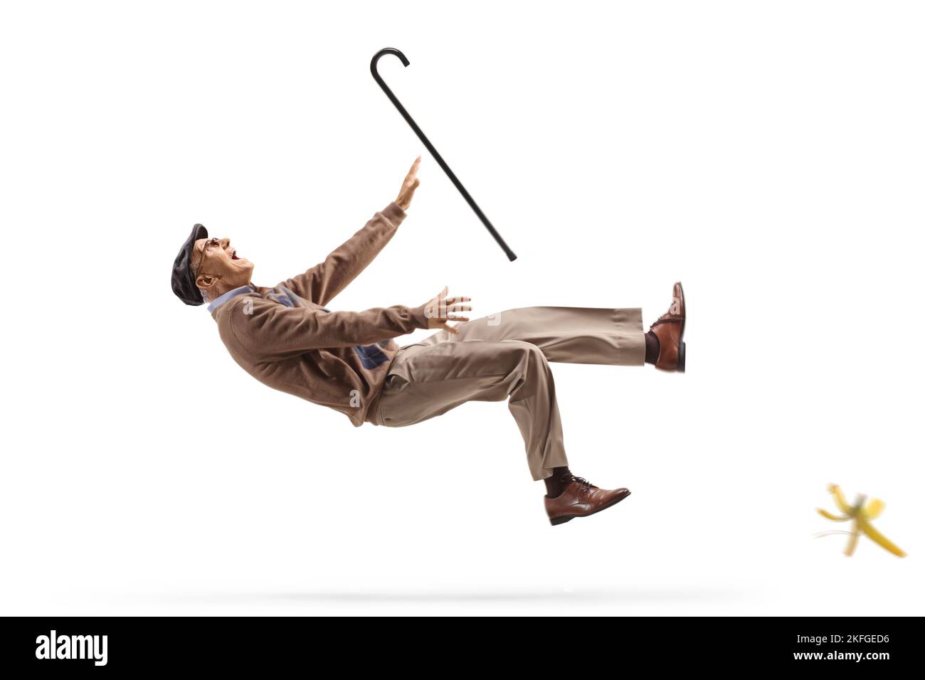 Elderly man with a walking cane slipping on banana peel isolated on