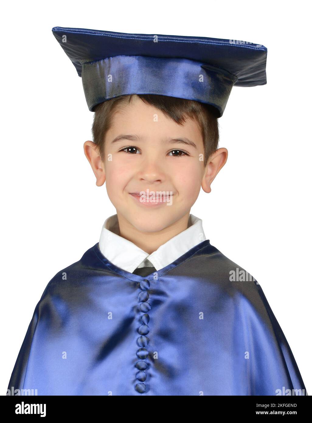 Smiling school-age boy in blue cap and gown Stock Photo