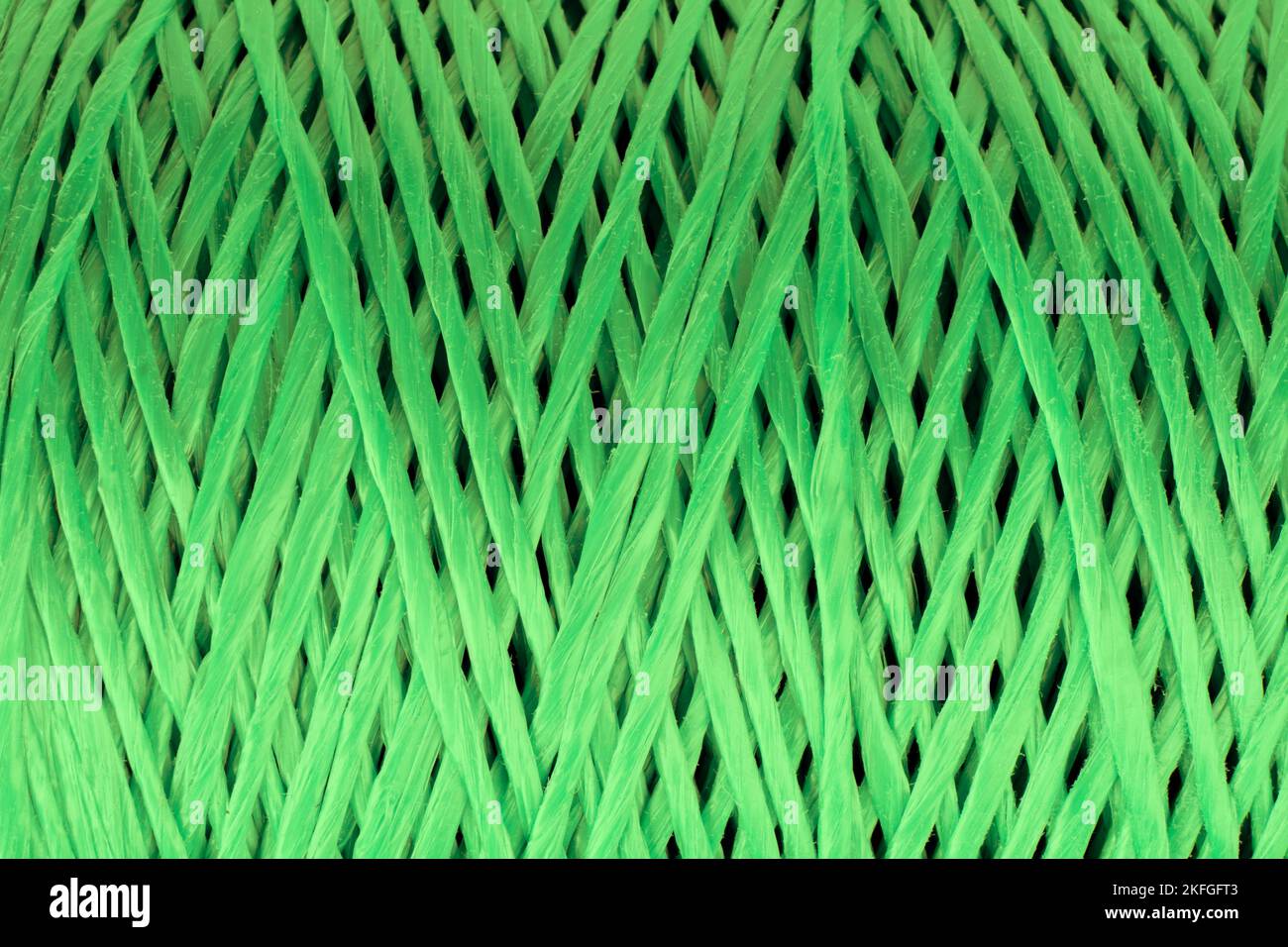 Coiled nylon rope texture background. Green rolled  striped nylon rope pattern. A coil of new colored rope surface Stock Photo
