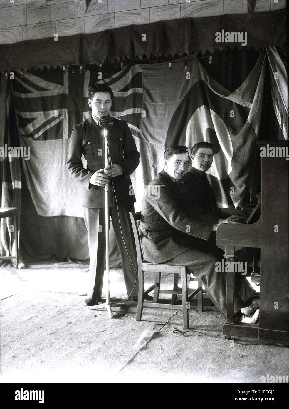 1949, historical, three airmen on a wooden stage, performing, two at the piano at the Longford Camp at RAF Ternhill, Market Drayton, Shropshire, England, UK Stock Photo