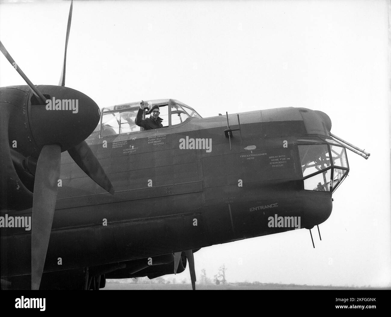 1948, historical, an RAF pilot waving from the cockpit of an Avro Lancaster Bomber at RAF Ternhill, Longford Camp, Market Drayton, England, UK. Designed by Roy Chadwick, the Lancaster was a WW2 heavy bomber made by Avro (A.V. Roe and Company), a British manufacturer founded in 1910 in Manchester, Lancashire, England, UK. The prototype of the Lancaster made its maiden flight in January 1941. The aircraft had a seven-made crew, with its average age being only 22 years old. Stock Photo