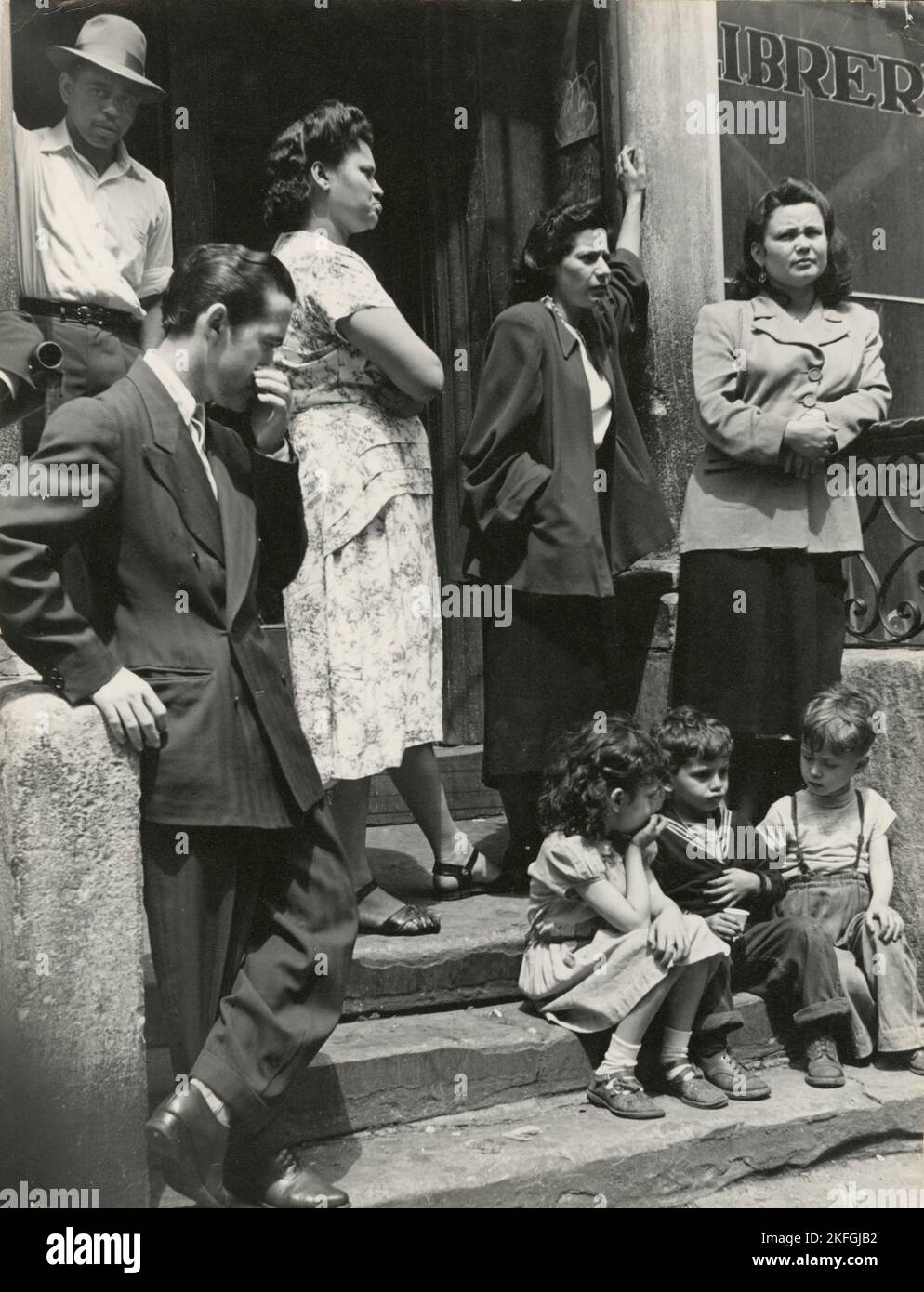 Group of men, women and children gathered on stoop, East Harlem, New York City, 1947 - 1951. Stock Photo