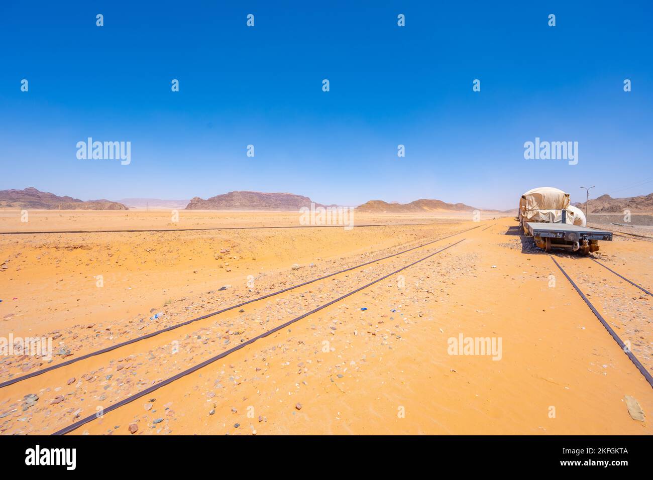 The sand buried train track at Wadi Rum Train Station in Wadi Rum Jordan Stock Photo