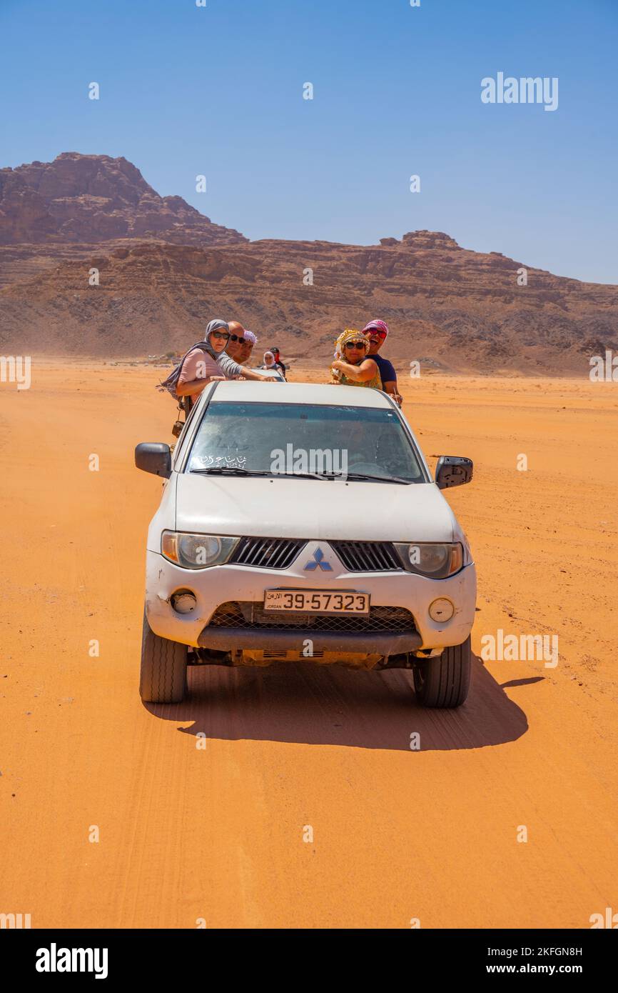 Tourists on a 4X4 safari in Wadi Rum Jordan Stock Photo