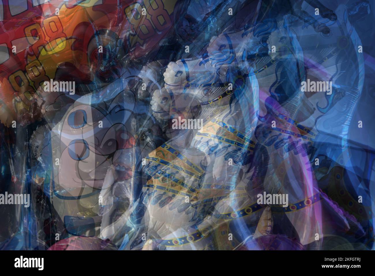 Multiple exposure of figural balloons in the wind at a Christmas fair market, colorful abstract art image, copy space, selected focus Stock Photo