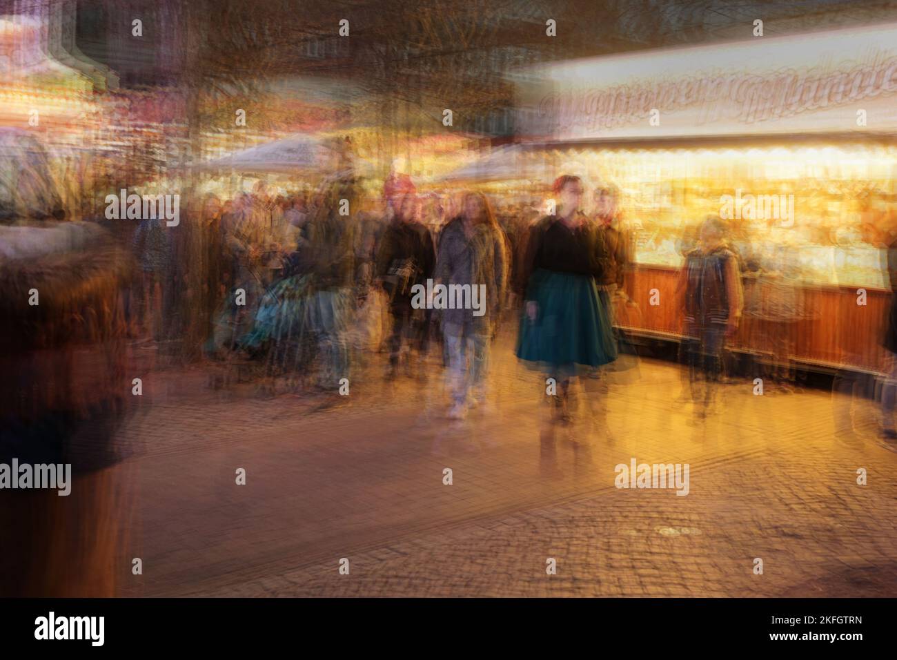 Multiple exposure of people walking on a Christmas fair market at night, colorful abstract image, copy space Stock Photo