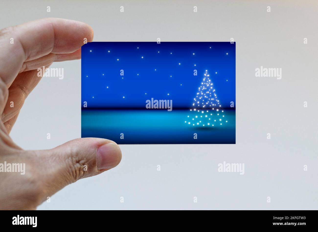 Hand holding a Christmas card Stock Photo - Alamy