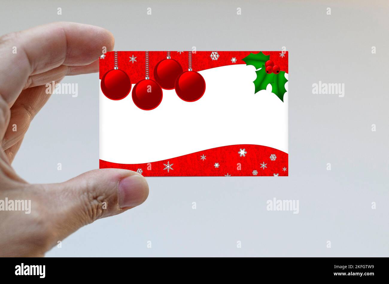 Hand holding a Christmas card Stock Photo - Alamy
