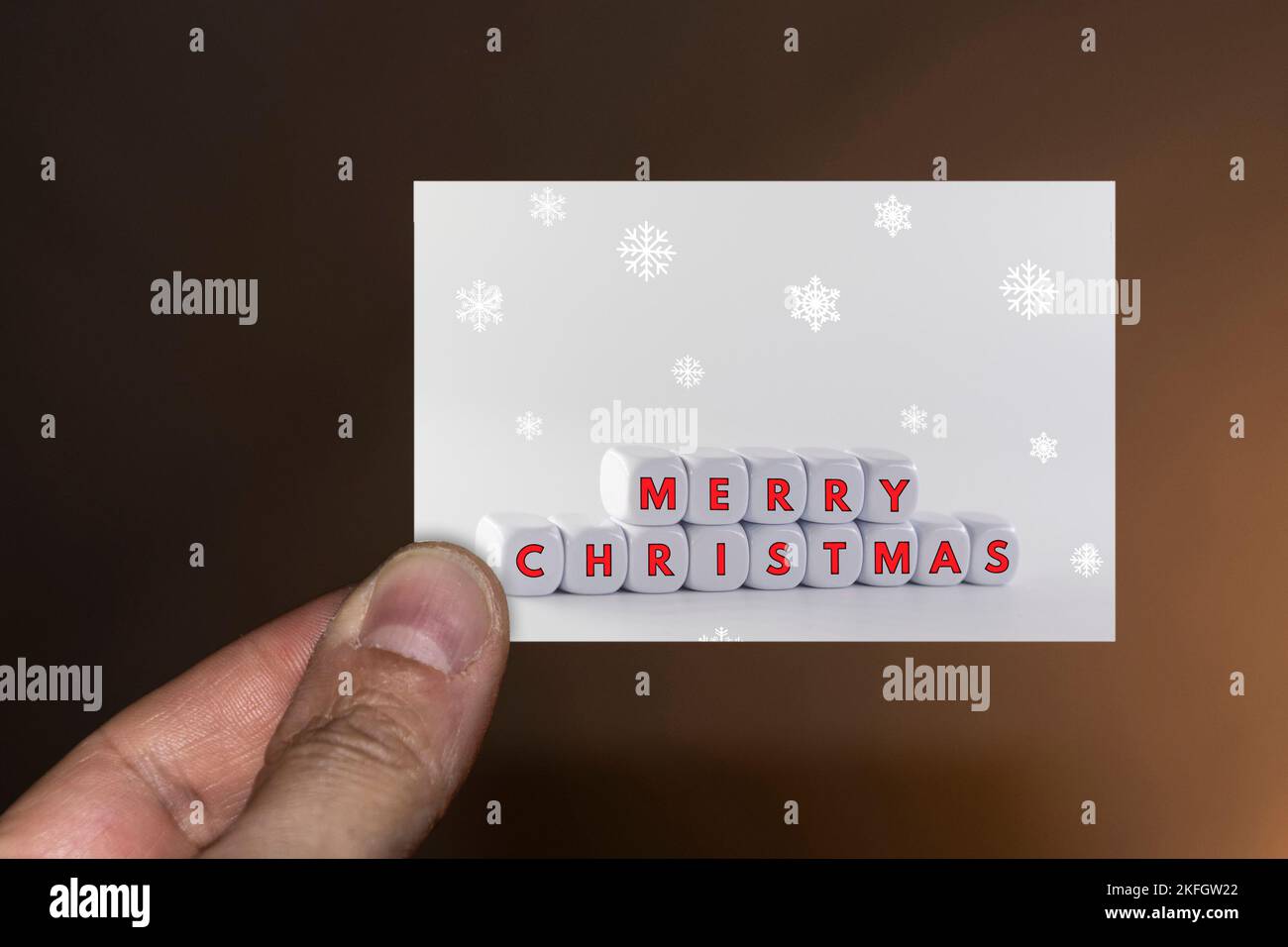 Hand holding a Christmas card Stock Photo - Alamy