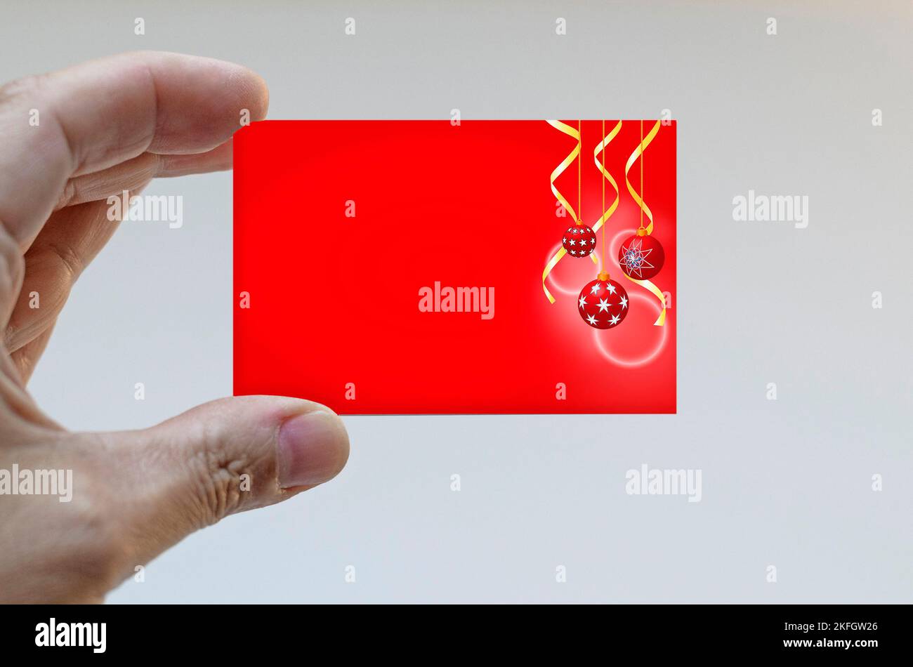 Hand holding a Christmas card Stock Photo - Alamy