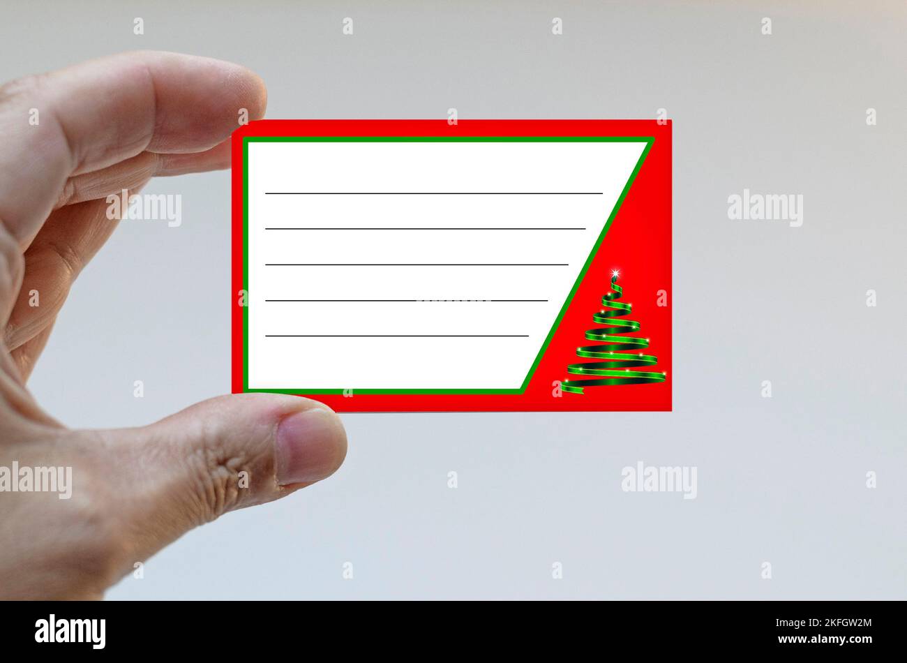 Hand holding a Christmas card Stock Photo - Alamy
