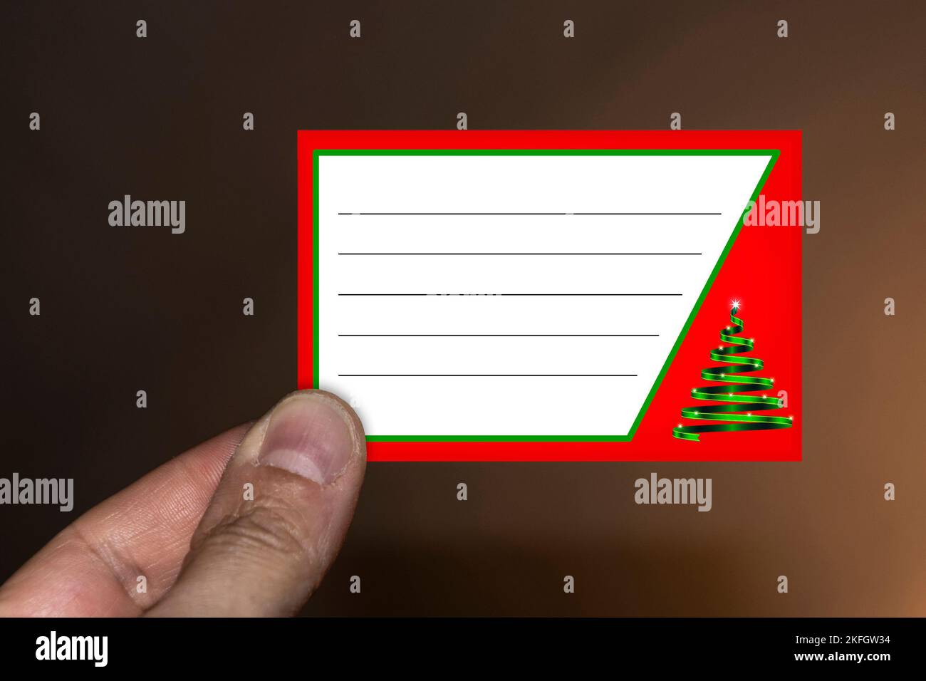 Hand holding a Christmas card Stock Photo - Alamy