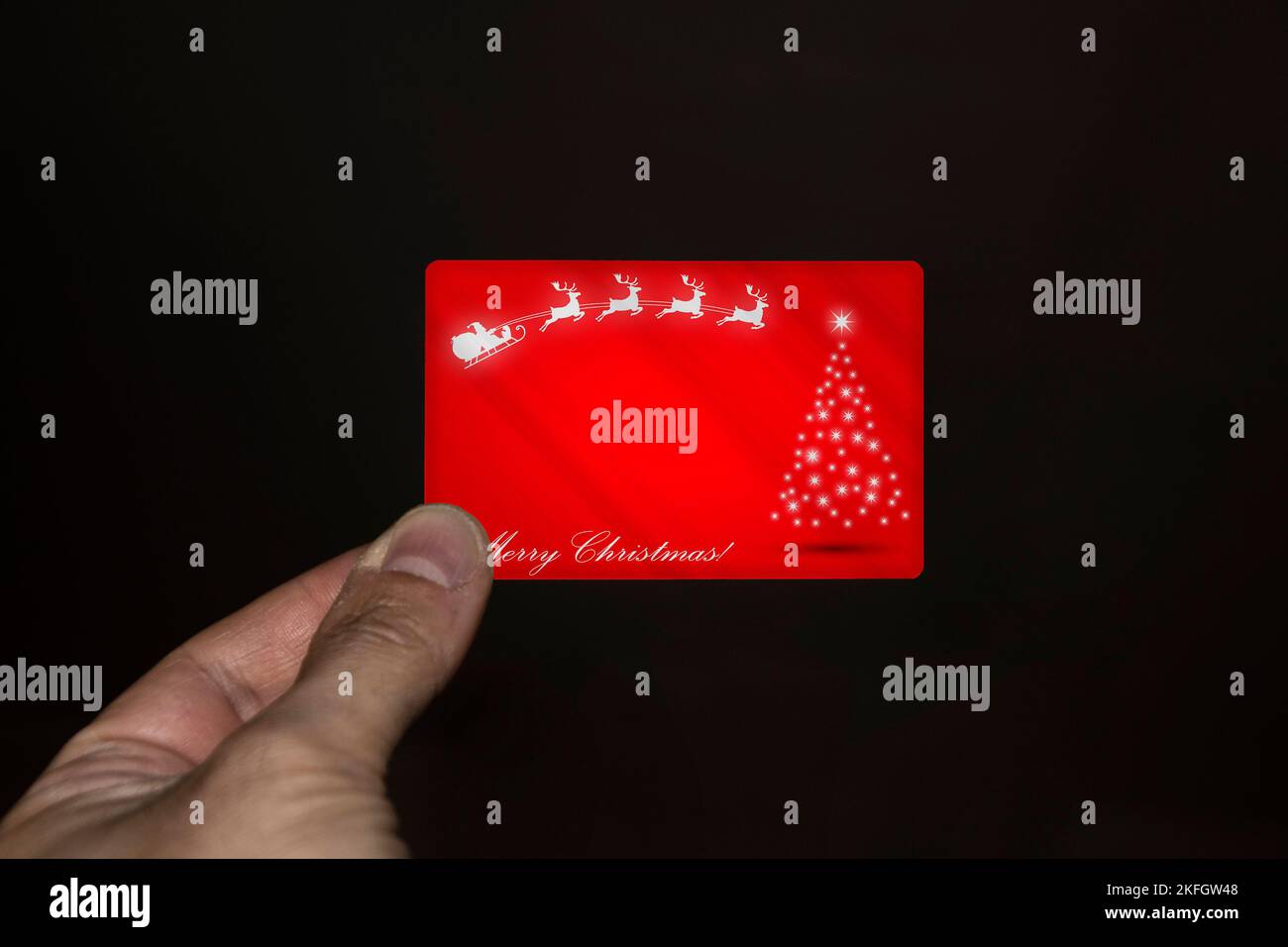 Hand holding a Christmas card Stock Photo - Alamy