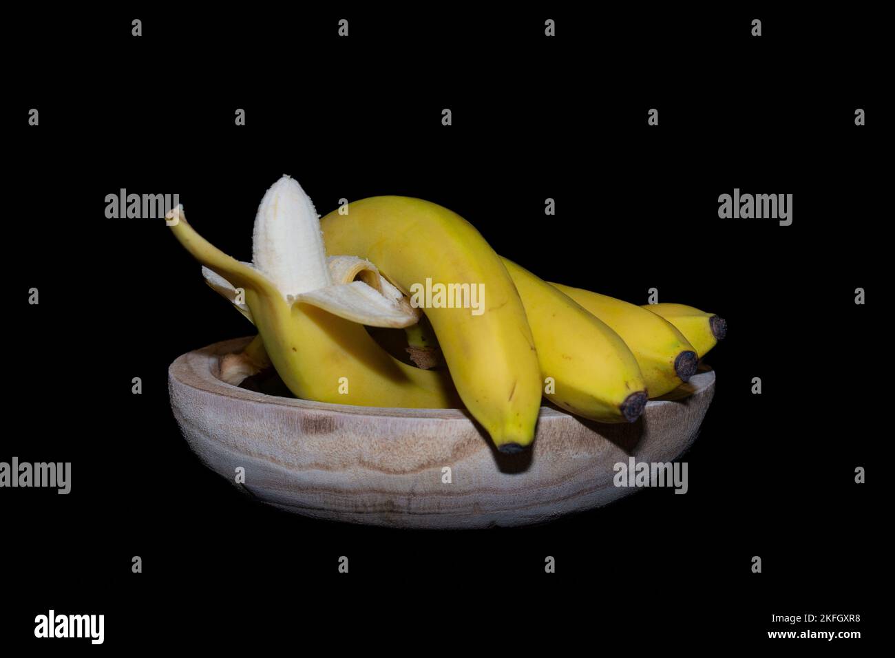 Yellow bananas on a black background. Stock Photo