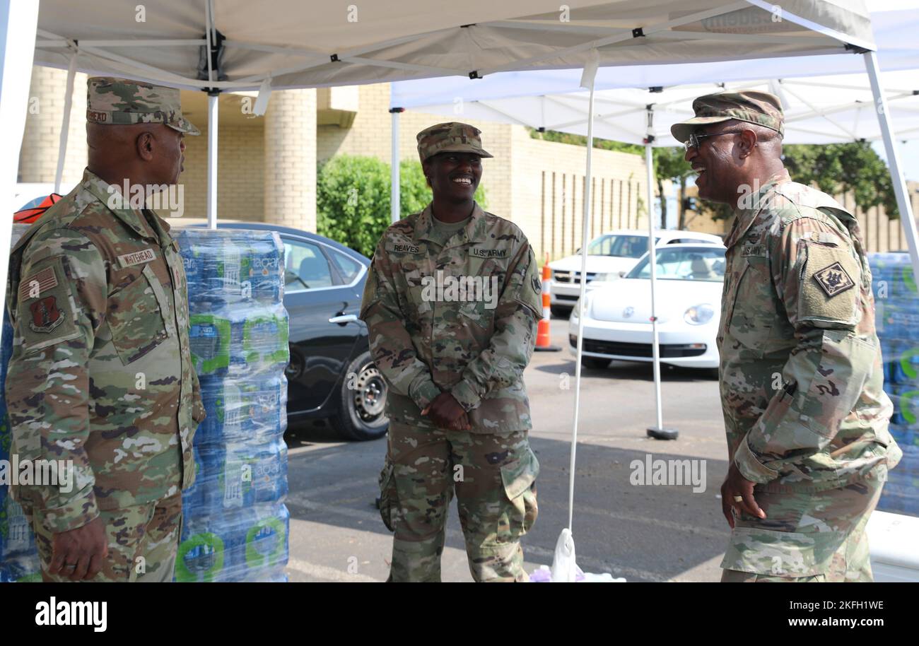 Senior Enlisted Advisor Tony Whitehead, senior enlisted advisor to the chief of the National Guard Bureau, and Command Sgt. Maj. Silvester Tatum, senior enlisted leader of the Mississippi National Guard, 2nd Lt. Randia Reaves, 184th Sustainment Command, during a visit to Metrocenter Mall in Jackson, Mississippi, Sept. 16, 2022. Whitehead visited the Soldiers who were distributing water to assist with the Jackson Water Crisis. Stock Photo
