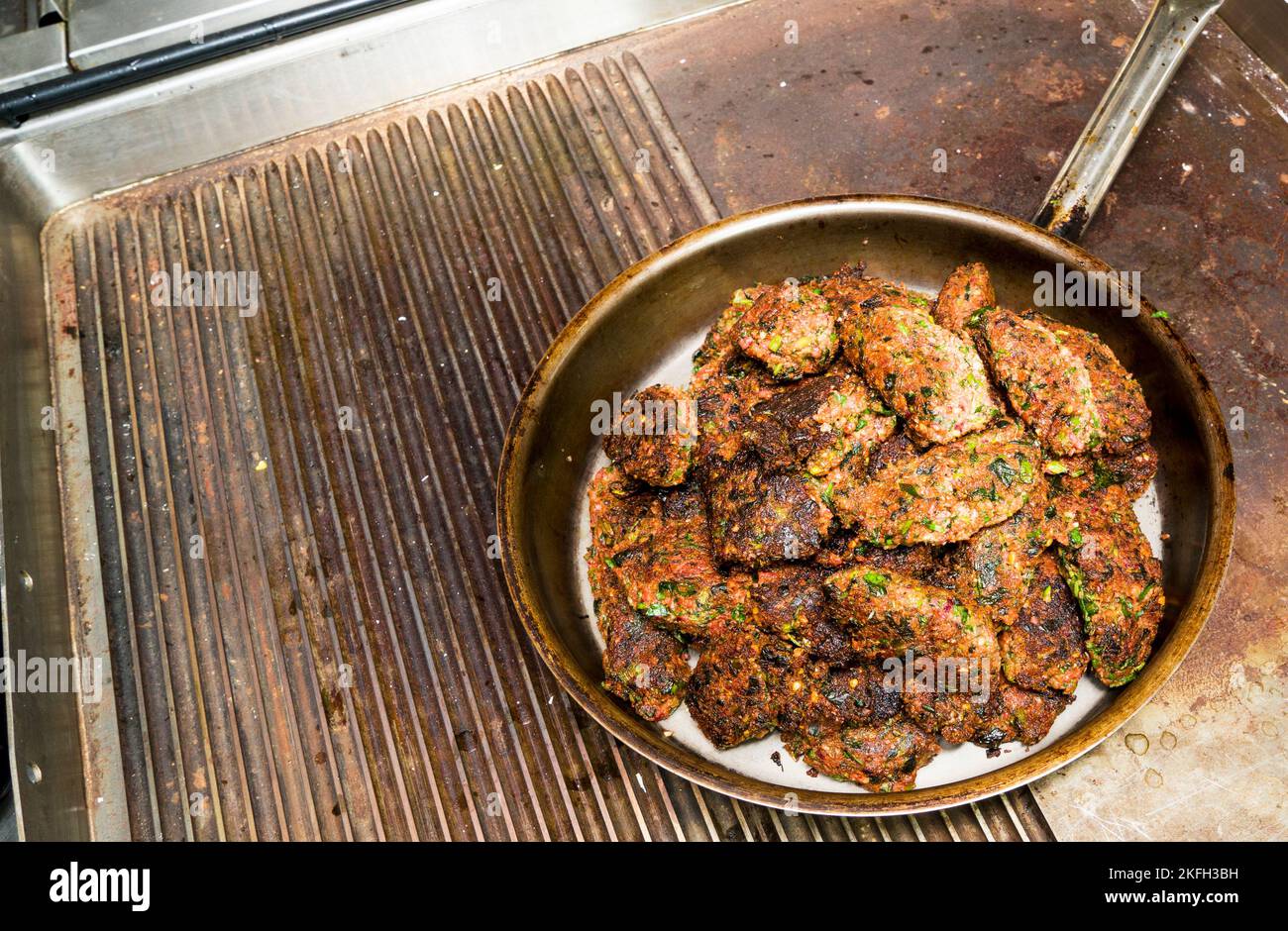 fried vegetable cutlets of walnuts in an iron pan on a gas, electric stove. Health food.Vegetarian diet Stock Photo