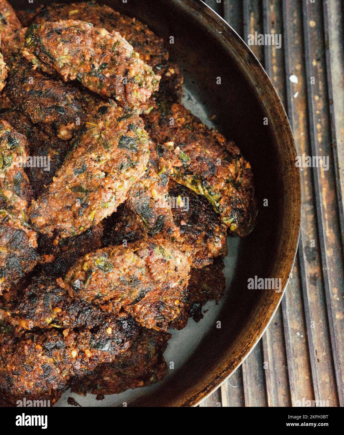 fried vegetable cutlets of walnuts in an iron pan on a gas, electric stove. Health food.Vegetarian diet Stock Photo