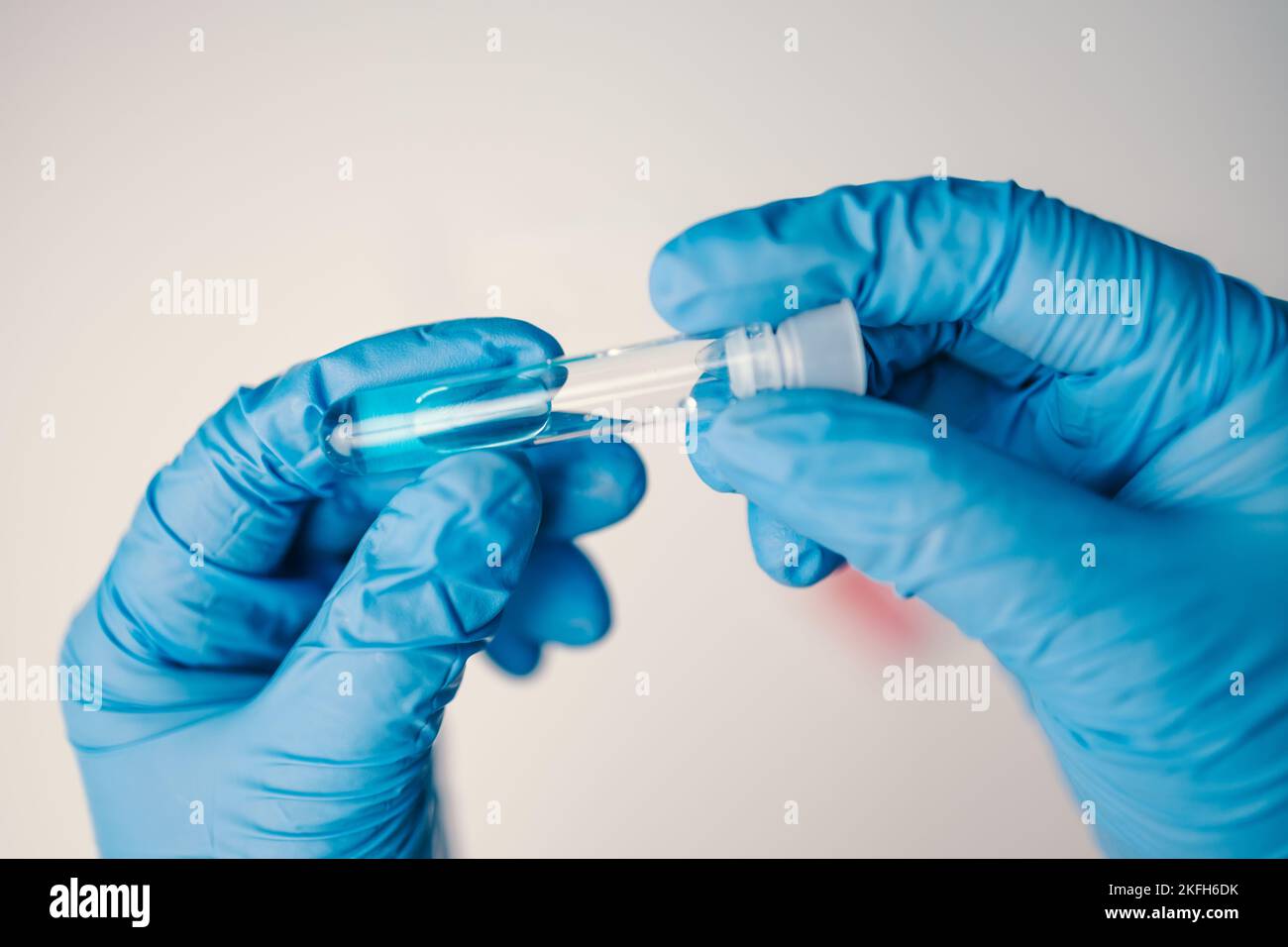A laboratory employee taking sample PCR microtubes with cotton swab test. Diagnostic testing for