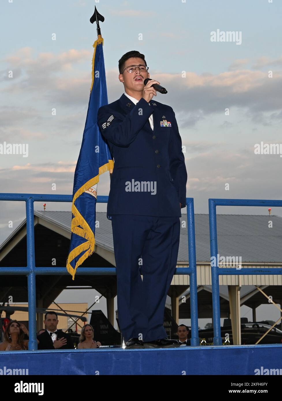 An Airman sings The Star Spangled Banner at the Air Force Ball at