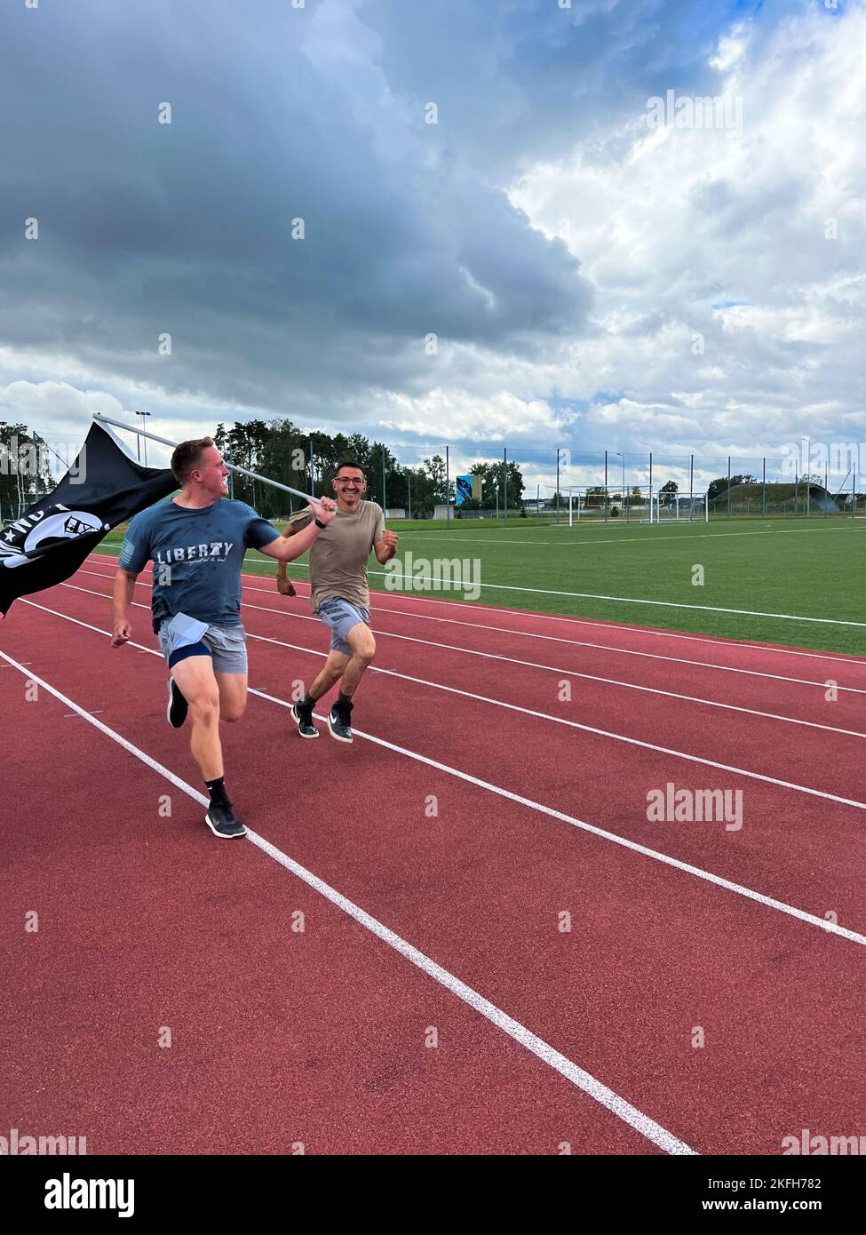 Members of the 90th Expeditionary Fighter Squadron run while carrying the Prisoner of War/Missing in Action (POW/MIA) flag during a 24 hour remembrance run for those who were prisoners of war and those who are still missing in action, Sept. 16, 2022 at Łask Air Base, Poland. The 90th EFS forward deployed to Poland in support of NATO’s Air Shielding mission to enhance the defense posture on NATO’s eastern flank. 43 men and women of the 90th carried the flag for more than 160 miles over the 24 hour period to demonstrate that the American prisoners of war and missing in action are not forgotten. Stock Photo