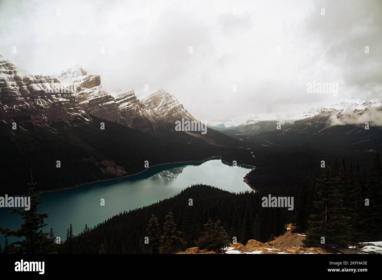 A scenic shot of Peyto Lake in Banff National Park surrounded by snowy ...