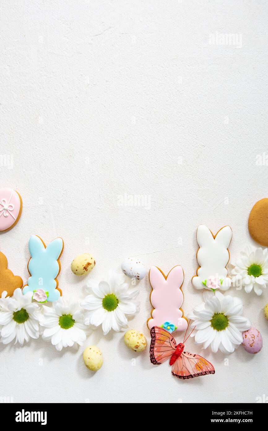 Top view of Easter cookies and decor chocolate eggs bunny copy space Stock Photo
