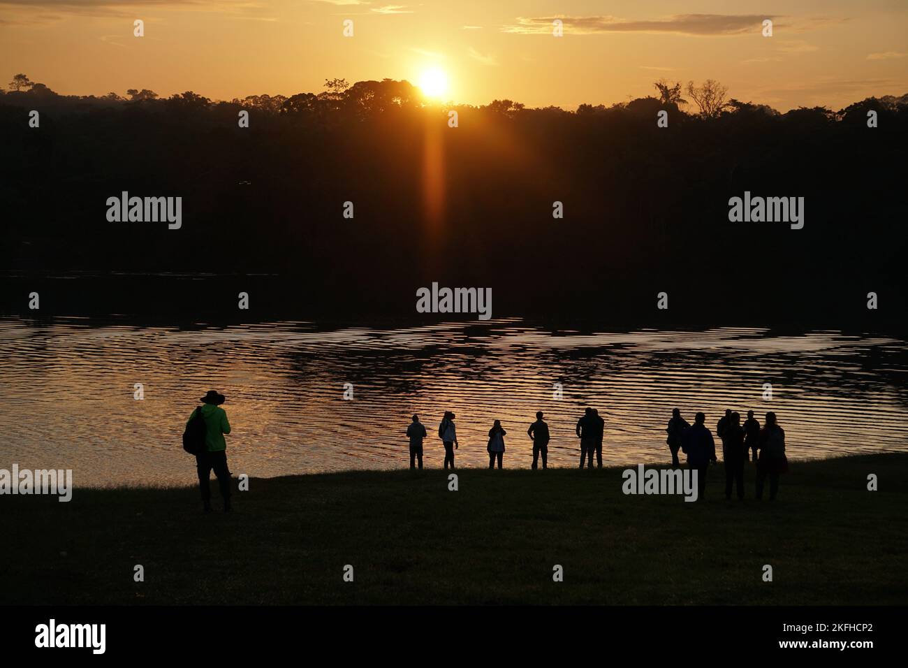 People watching a sunset in Vaupes River, Colombia Stock Photo