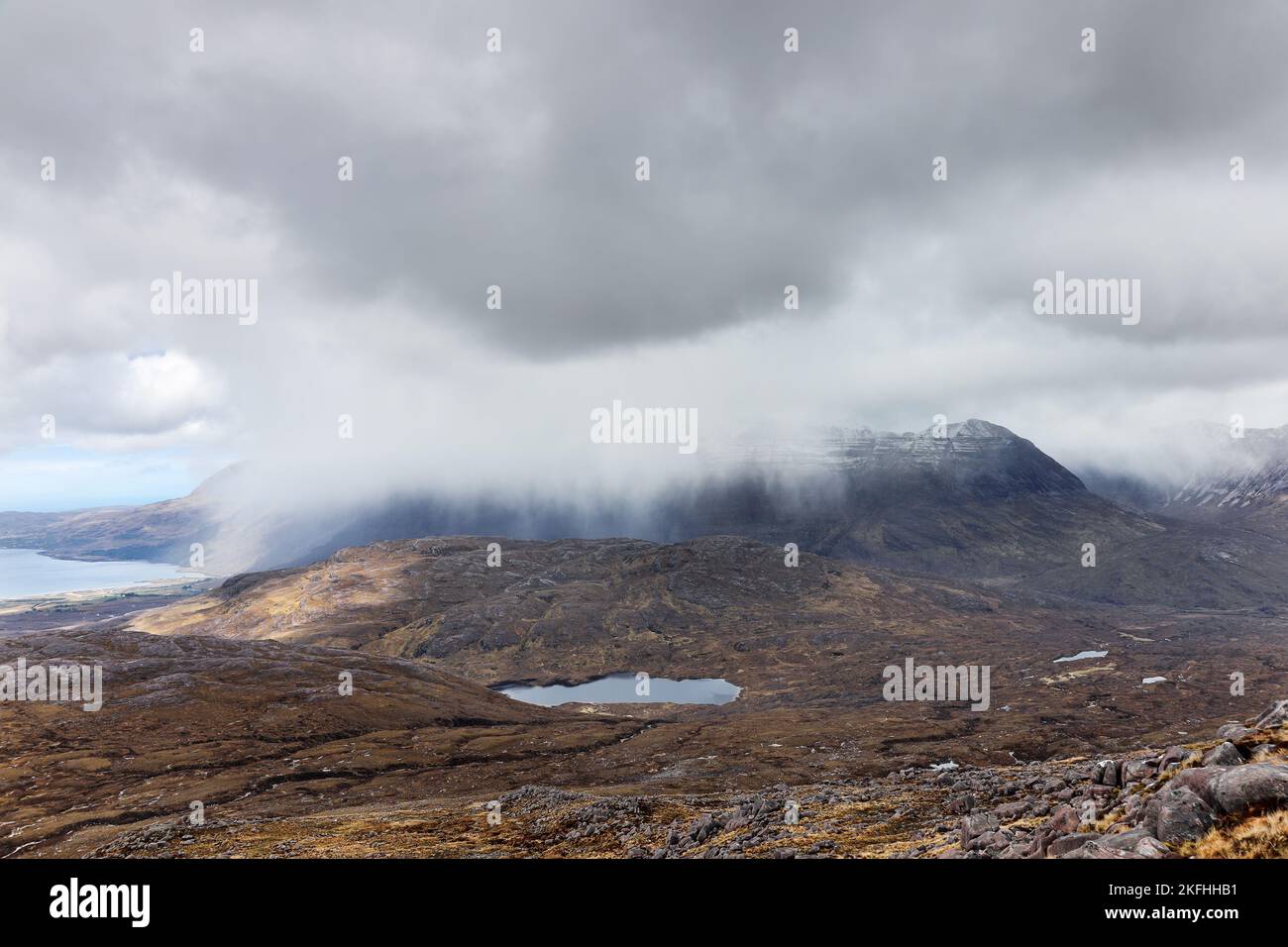 The Mountain of Liathach Viewed from the Lower Slopes of Beinn Liath Mhor as a Heavy Snow Shower Sweeps Past, Torridon, Highland, Scotland, UK Stock Photo