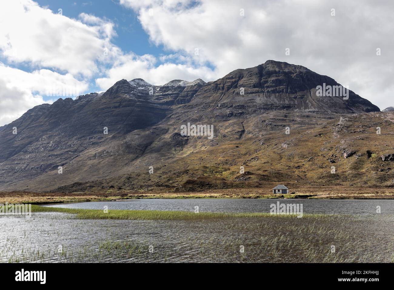 The Mountain of Liathach Enveloped in Cloud as Snow Shower Sweeps Across its Flanks, Viewed across Lochan an Lasgair, Torridon, Scotland, UK Stock Photo