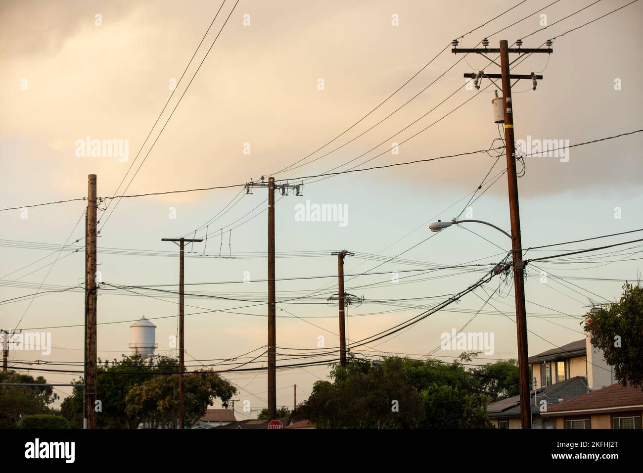 Street lights and power lines frame the historic water tower of Artesia