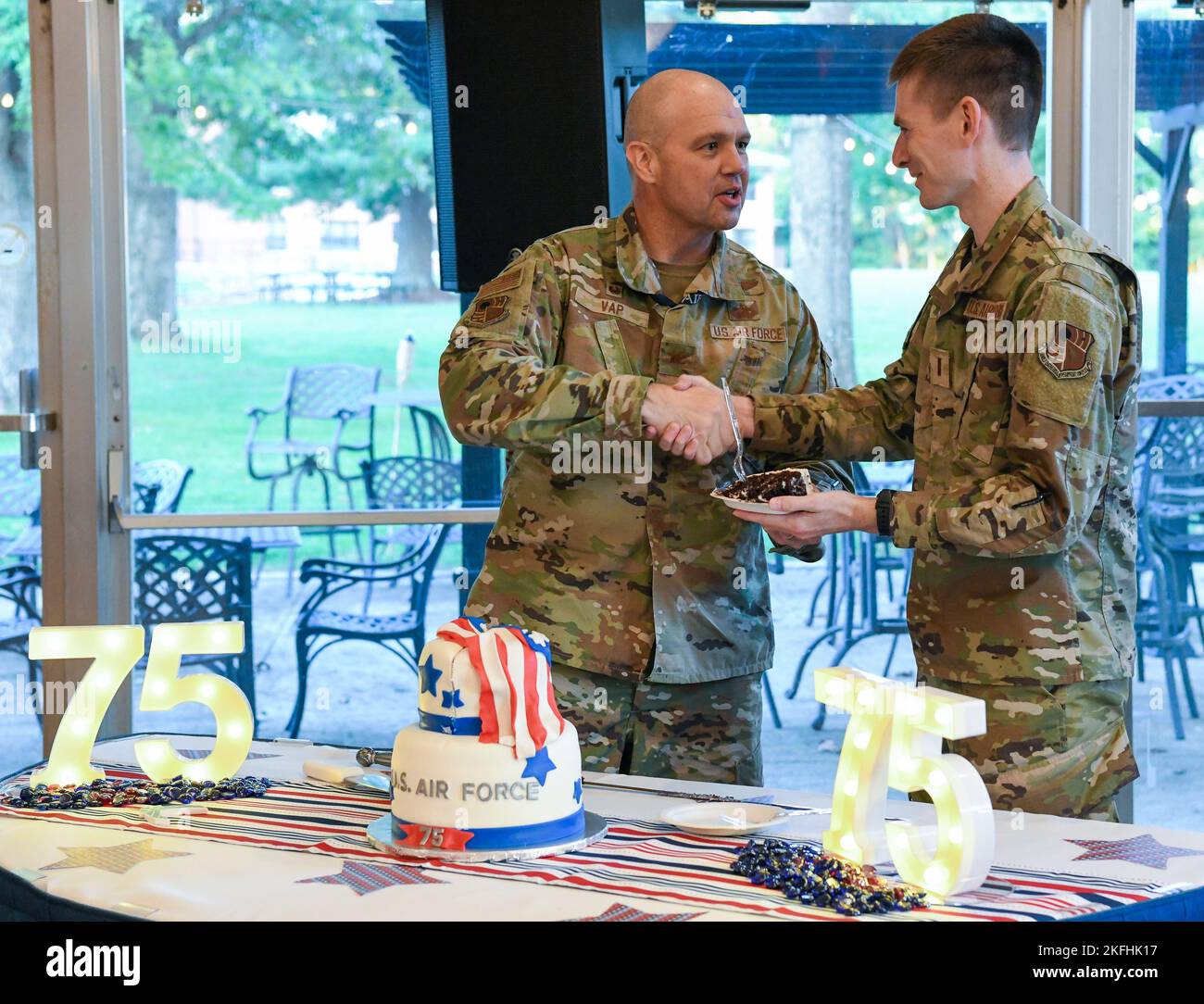 Col. Jason Vap, commander, 804th Test Group, Arnold Engineering Development  Complex, serves the first piece of cake to 2nd Lt. Ben West, 718th Test  Squadron, 804th Test Group, during a celebration of