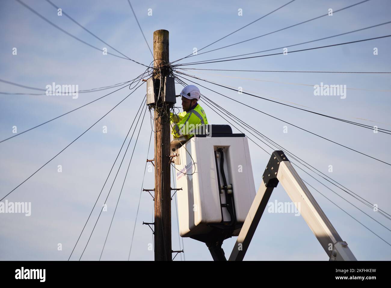 BT openreach engineer working on telephone wires from a cherry picker Stock Photo